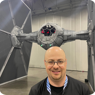 Reed Mascola standing in front of a full-sized Tie Fighter (Star Wars) 