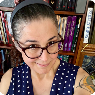 Photo of Gwendolyn Marshall in front of a book shelf.