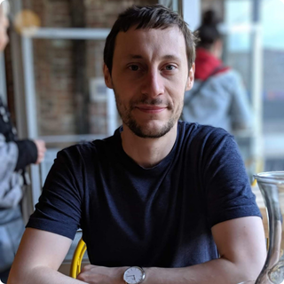 Jean Luc Lariviere-Lacombe sitting at a table